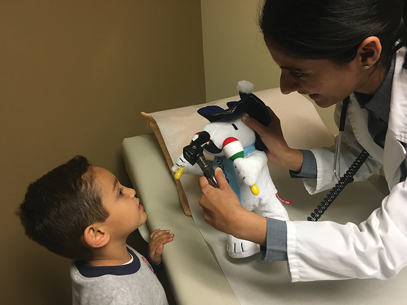 Resident Jasneet Dhaliwal, M.D., does a check up of Marco Macareno during a teddy bear clinic at Kaweah Delta’s Family Medicine Clinic. The clinic may soon become federally funded as part of Kaweah Delta’s new non-profit Sequoia Health and Wellness Centers. Photo courtesy of Kaweah Delta